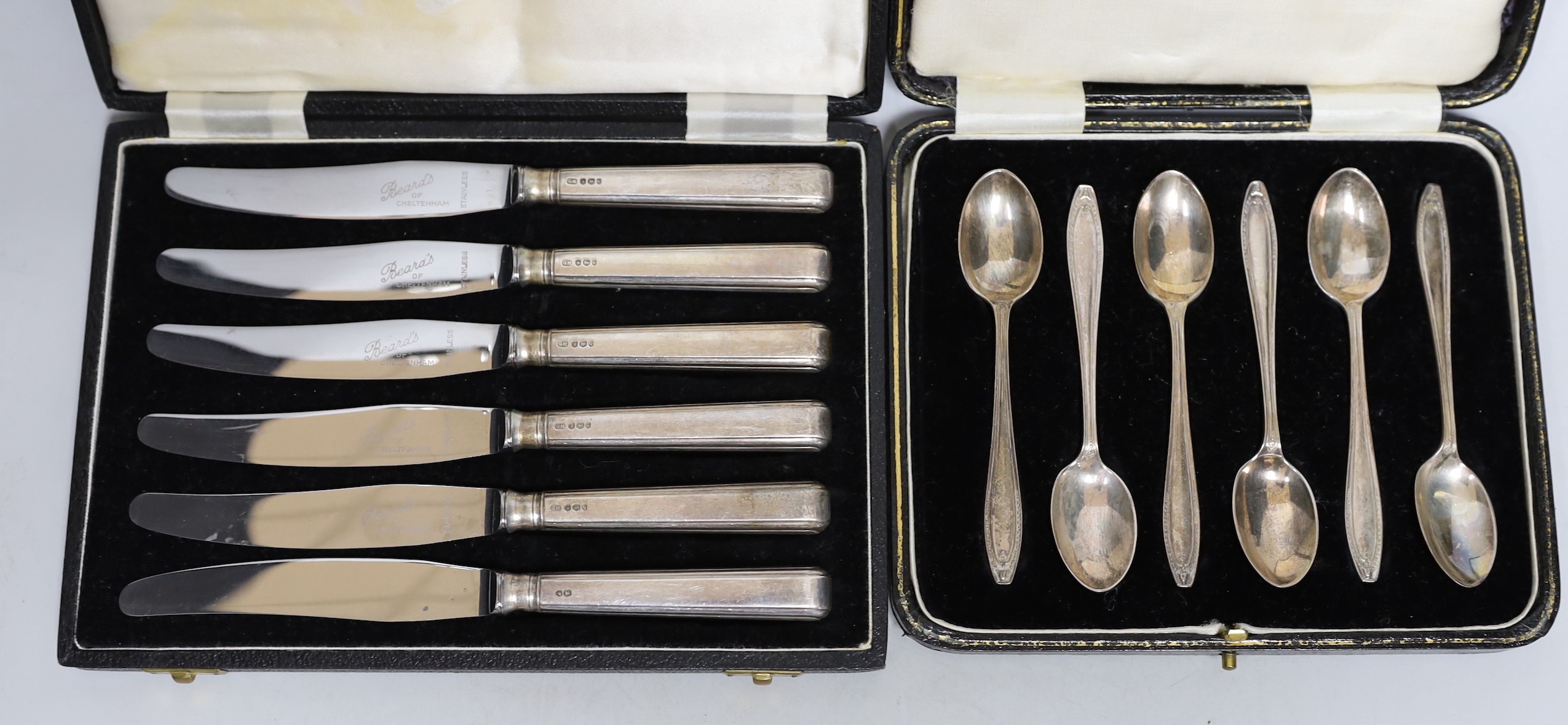 Three cased sets of silver flatware including a 1953 Commemorative dog nose spoon, six teaspoons and six tea knives.